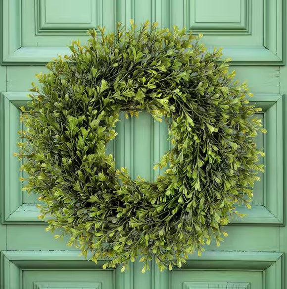Spring-themed plastic boxwood wreath with green foliage arranged in a circular silhouette.