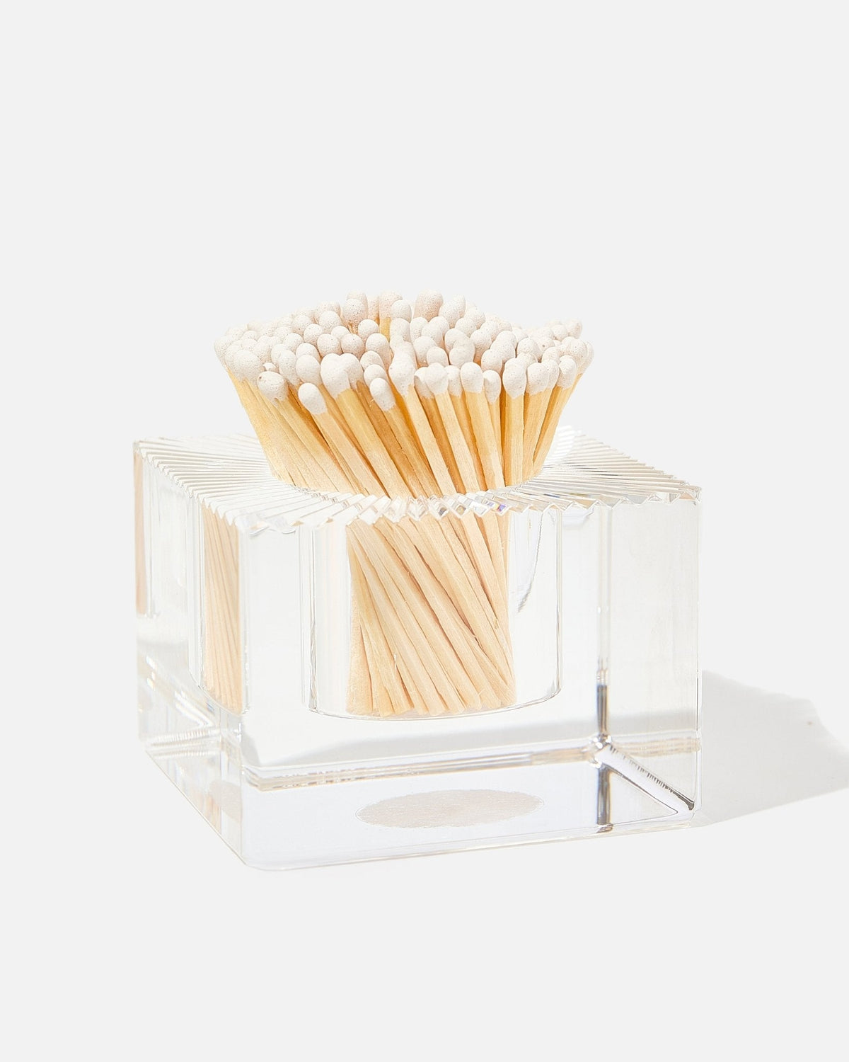 Clear acrylic square match striker with white-tipped wooden matches.