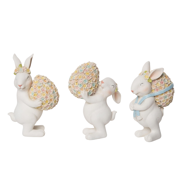 Resin figurine set featuring a floral bunny with pastel flowers and an egg on a stand.