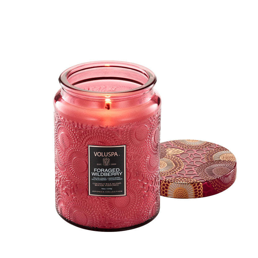 Large glass jar candle with natural wick in amber wax labeled Foraged Wildberry