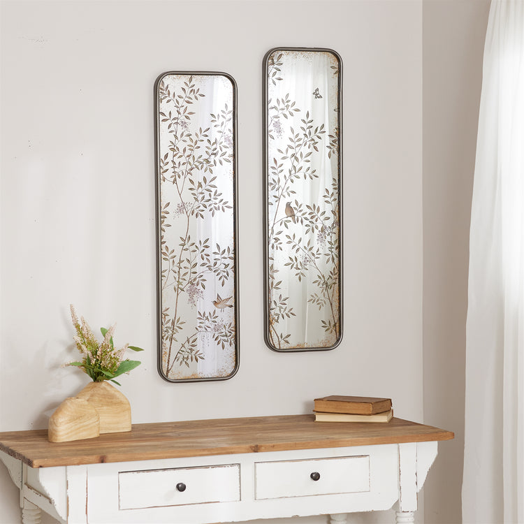 Tall rectangular wall mirror with a metal frame in black finish.