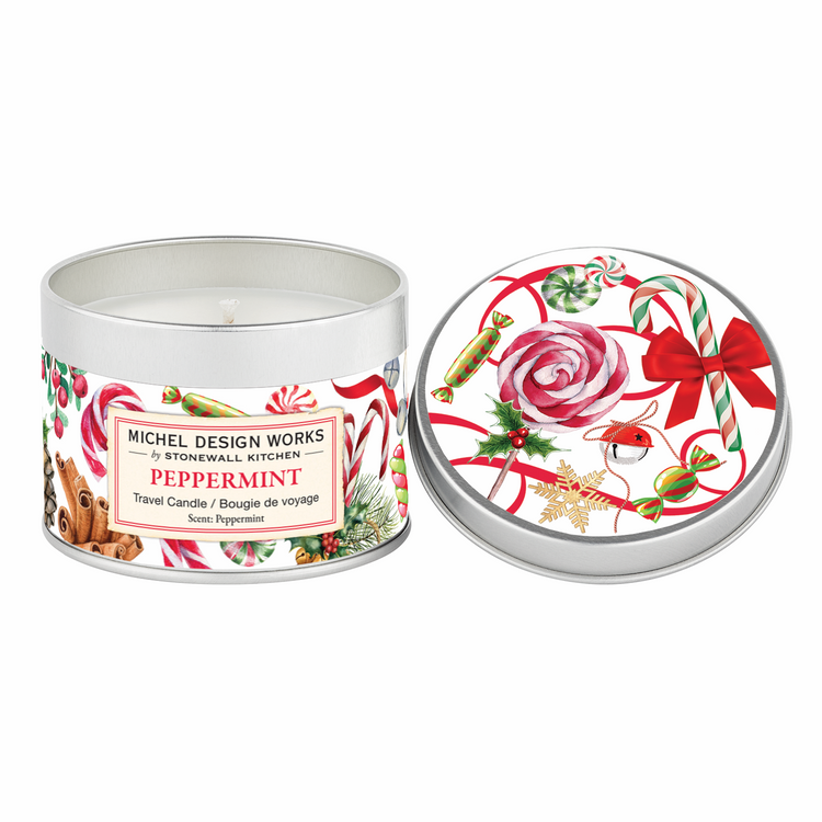 Travel candle in a clear glass jar with a white wax surface.