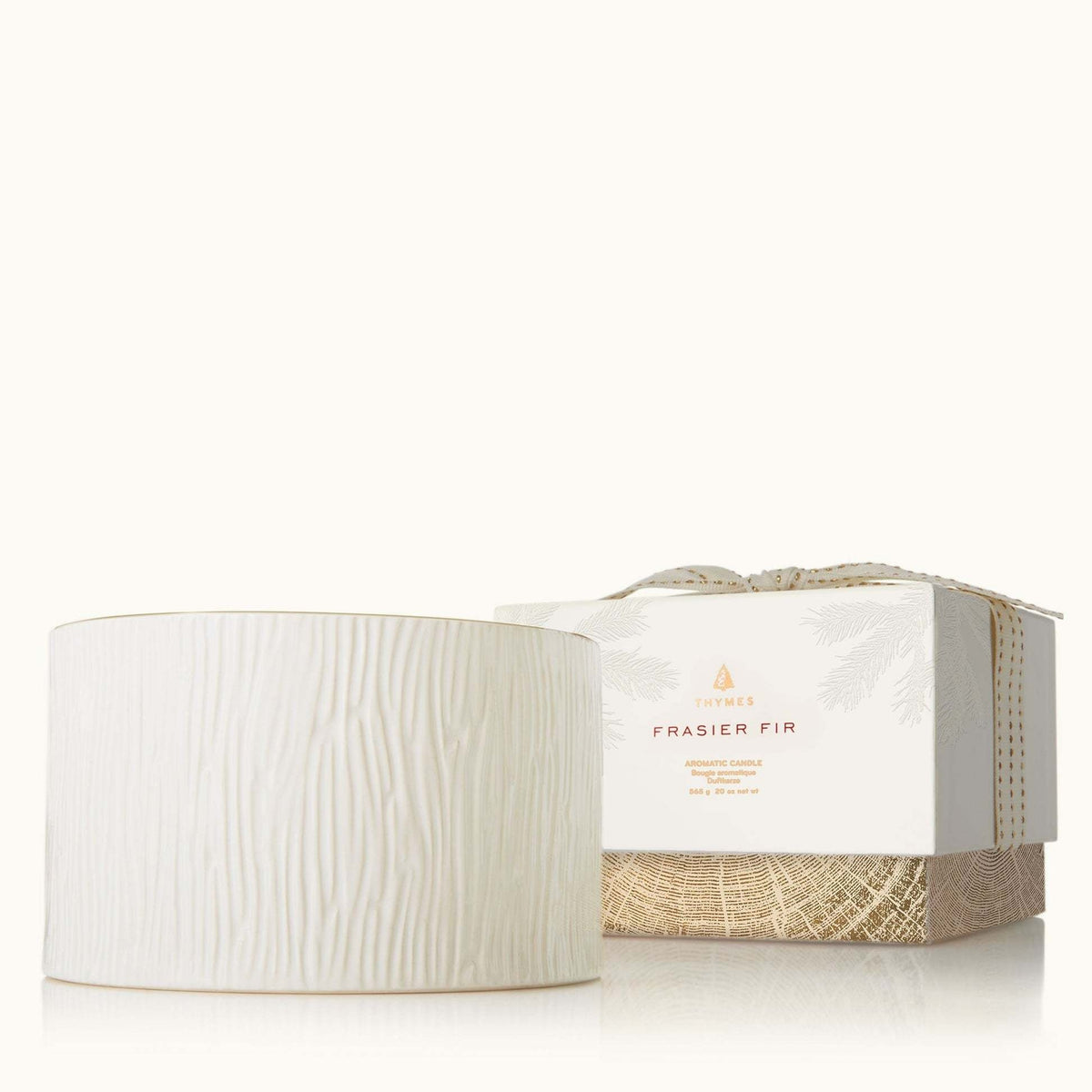 Ceramic poured candle with three wicks in Frasier Fir scent featuring a gold rim