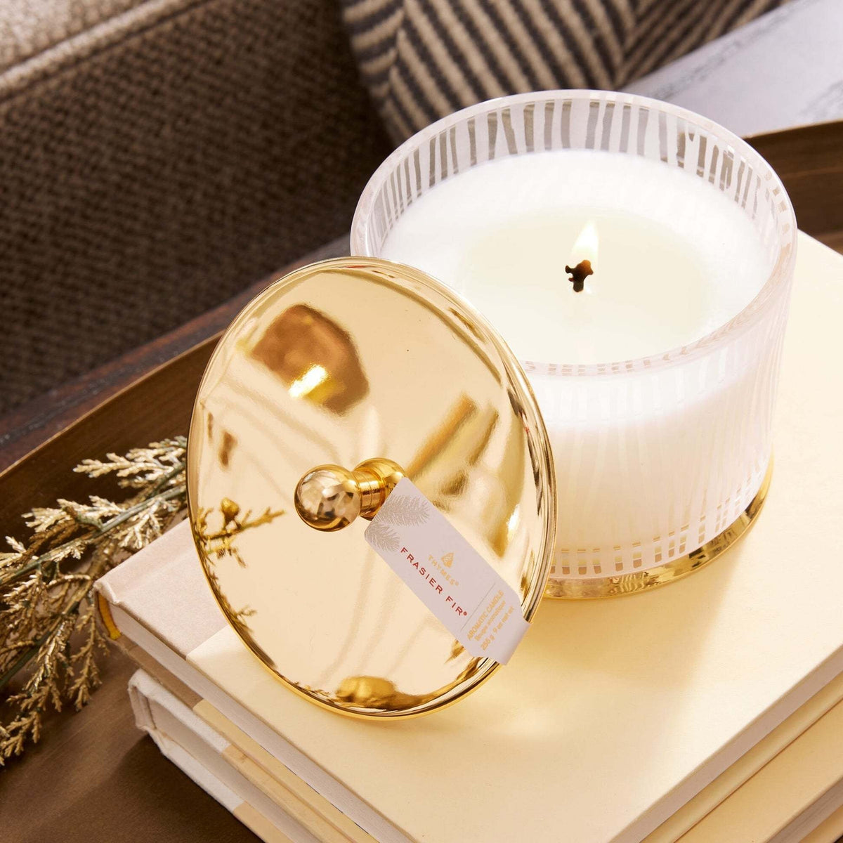 Medium poured candle with frosted wood grain finish, gold lid and base