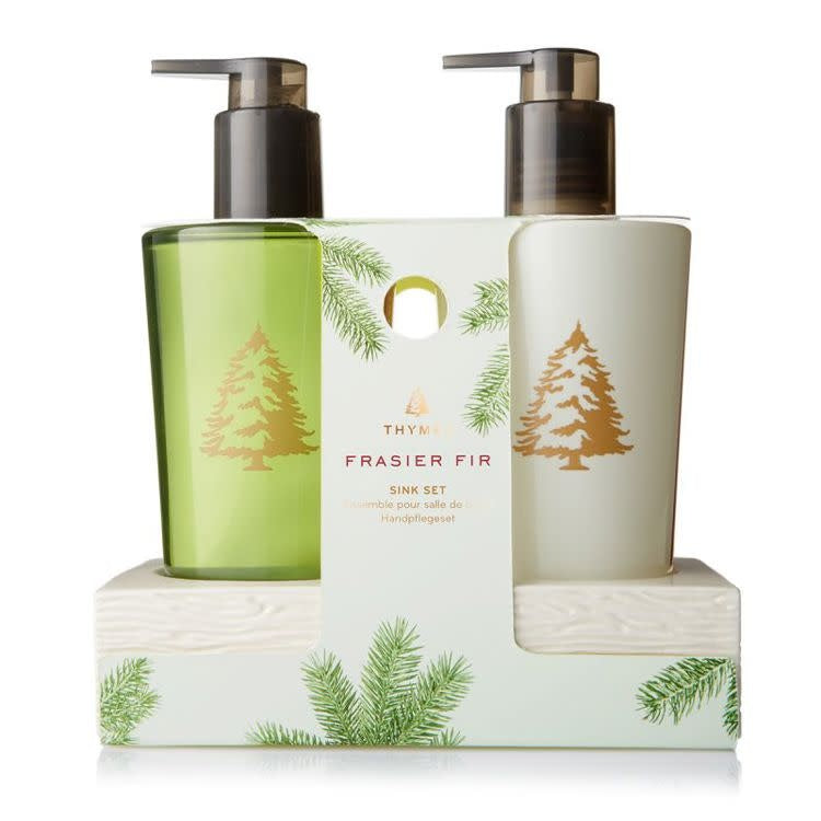 Ceramic caddy holding Frasier Fir hand wash and lotion in a forest-themed sink set.