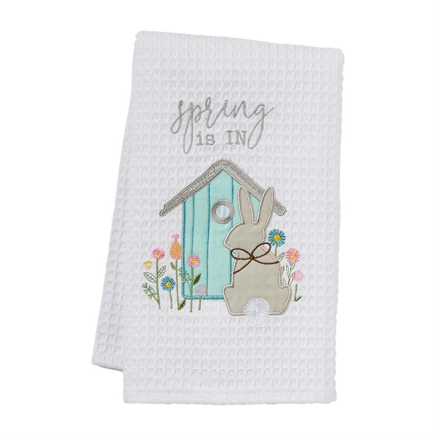 White waffle weave towel with embroidered spring scene featuring a bunny, birdhouse, and flowers.