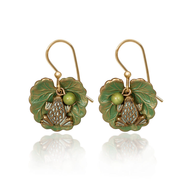 Layered frog perched on an open leaf with a dangling bead accent in mixed metals and gold-plated earwires.