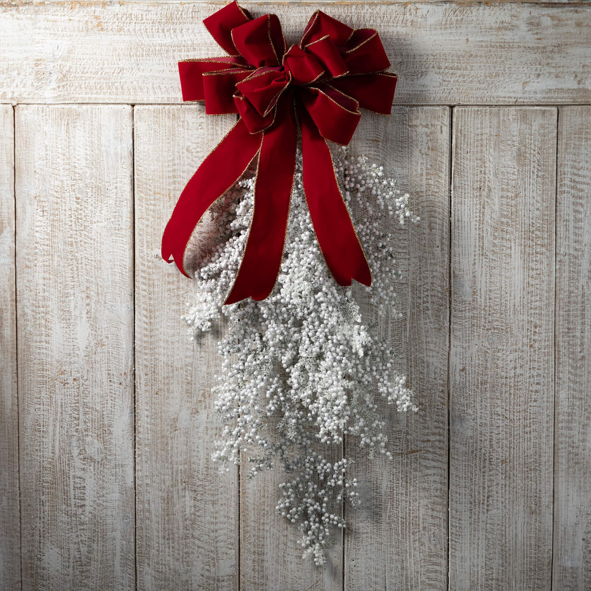Plastic frosted juniper berry swag with greenery and white berries.