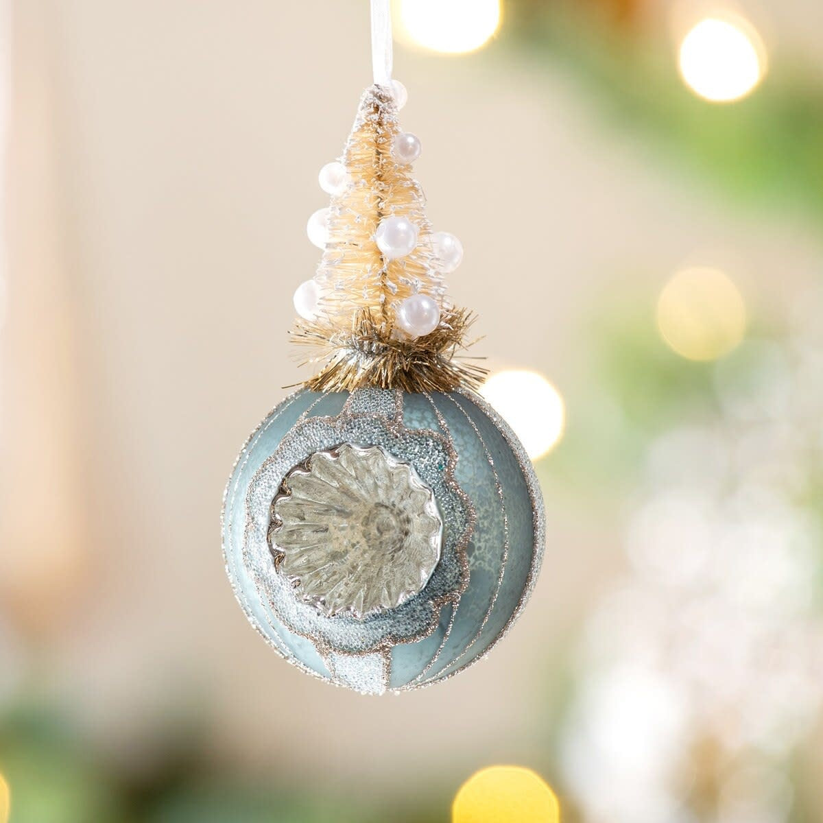 Antique blue frosted sisal tree ornament on a reflector ball with cream and sage green details.