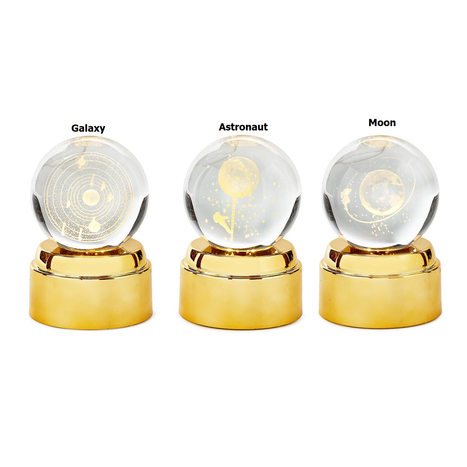 Three rotating crystal ball nightlights with Galaxy, Astronaut, and Moon designs on gold bases.