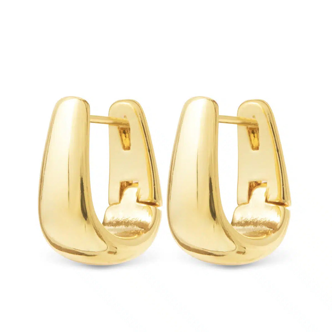 A pair of Edna polished gold elongated huggie earrings with a sleek, curved design.