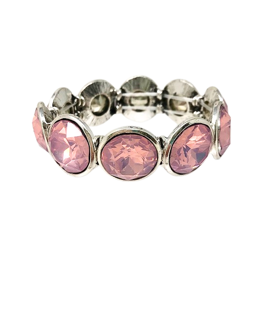Silver metal stretch bracelet featuring large, round pink opalescent crystals in bezel settings.