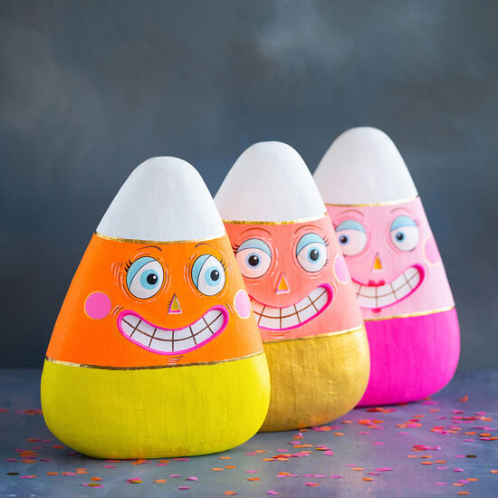 Candy corn fiber pulp display stand with orange, yellow, and white triangular shapes.