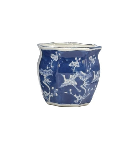 White ceramic planter pot with blue crane motif, fluted sides, and chinoiserie pattern.