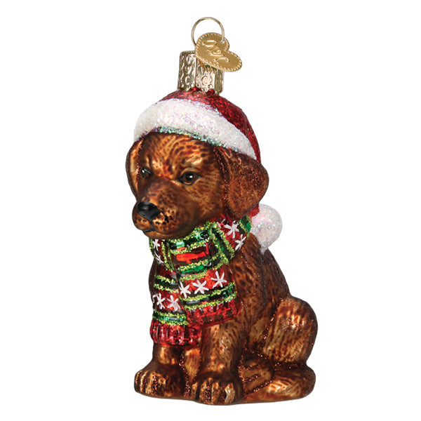Holiday Chocolate Labrador Pup glass ornament wearing a red Santa hat and a festive scarf.