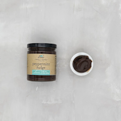 Bottle of dark chocolate peppermint fudge sauce with a white label.