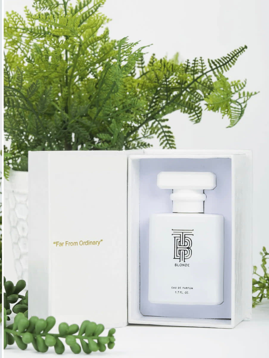 Thomas Blonde Eau De Parfum bottle with gold metal tag featuring an alligator print pattern.