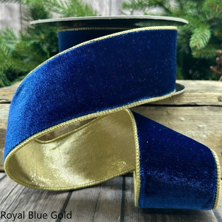 2.5-inch wide royal blue velvet ribbon with gold metallic edges on a spool.