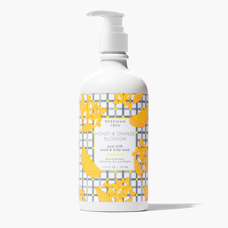 Beekman 1802 Honey & Orange Blossom goat milk hand and body wash in a white pump bottle.