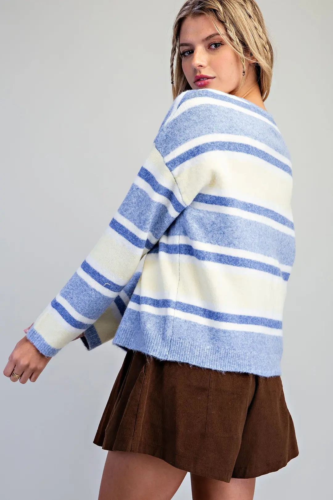 Back view of a woman wearing the Nova Striped Button Front Cardigan in blue and white stripes.