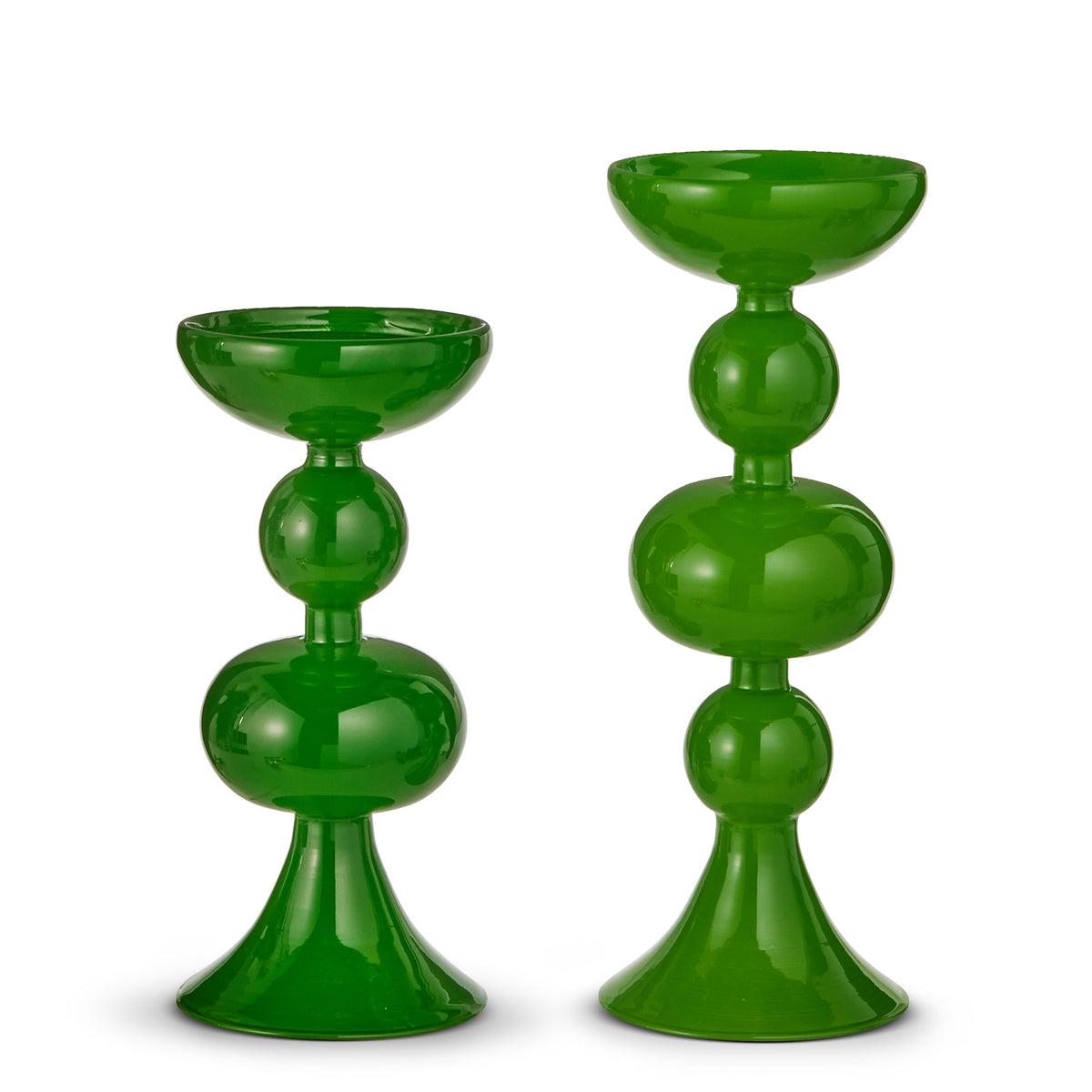 Glass candle holder in shade green holding a taper candle