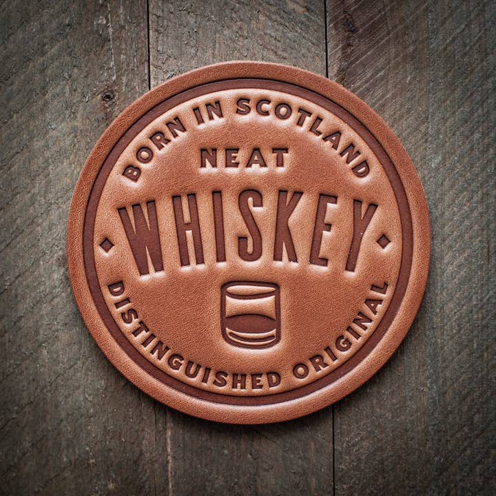 Square brown leather coaster with a smooth texture.