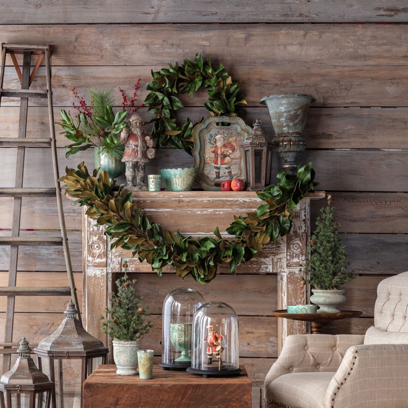 Santa Bearing Gifts Tray displayed on a rustic mantel with Christmas greenery and decor.
