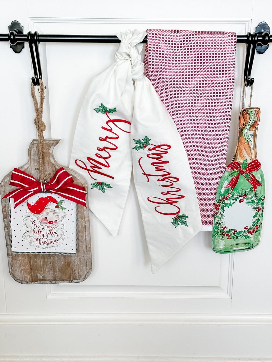 Mini Beck's Holly Jolly Santa ornament with red suit, white beard, green holly pattern background.