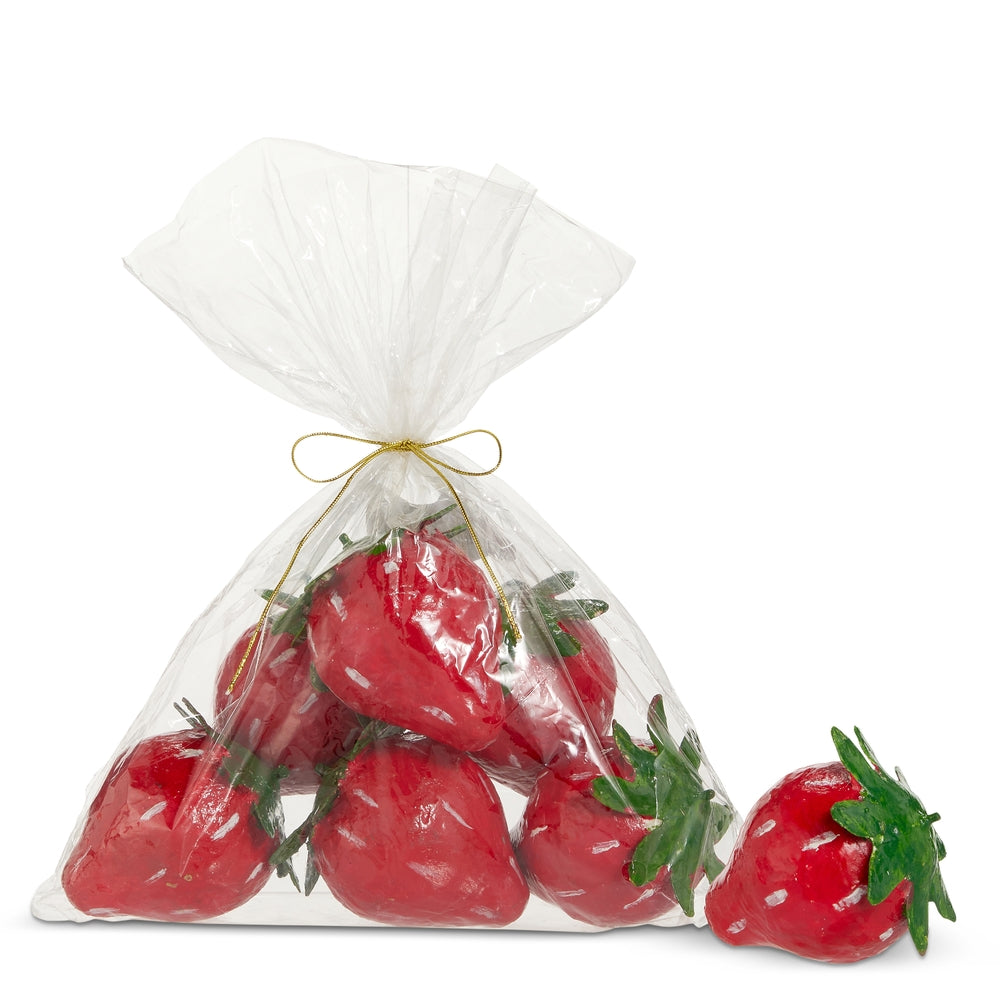 Paper mache strawberries in a clear gift bag tied with a gold ribbon.