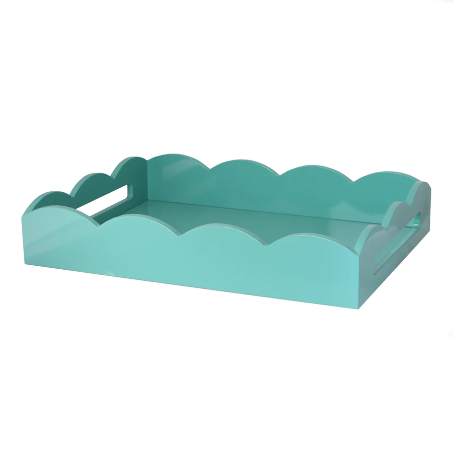 Turquoise lacquered scallop serving tray with cream velvet base.