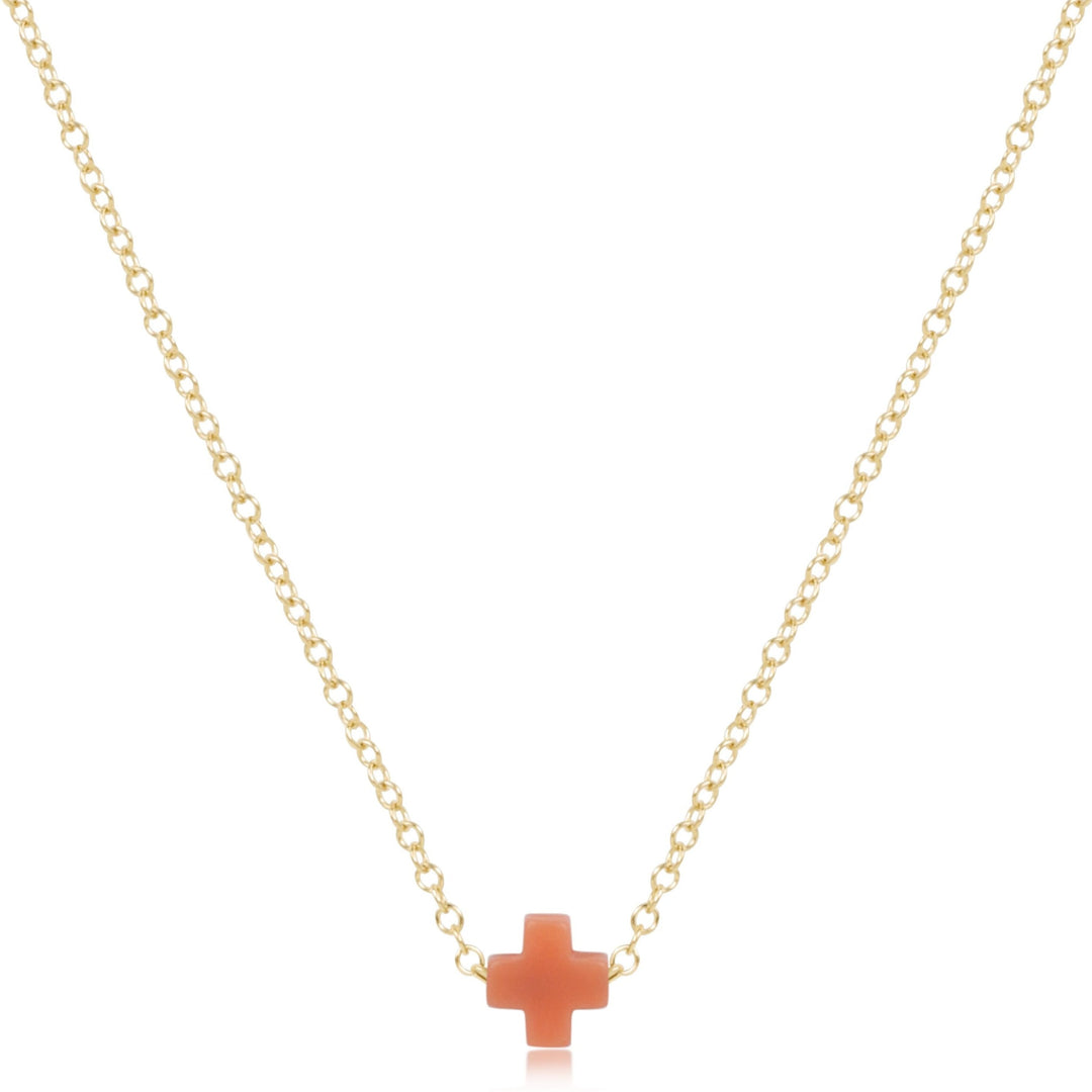 16-inch 14kt gold-filled chain necklace featuring a small coral-colored signature cross pendant.