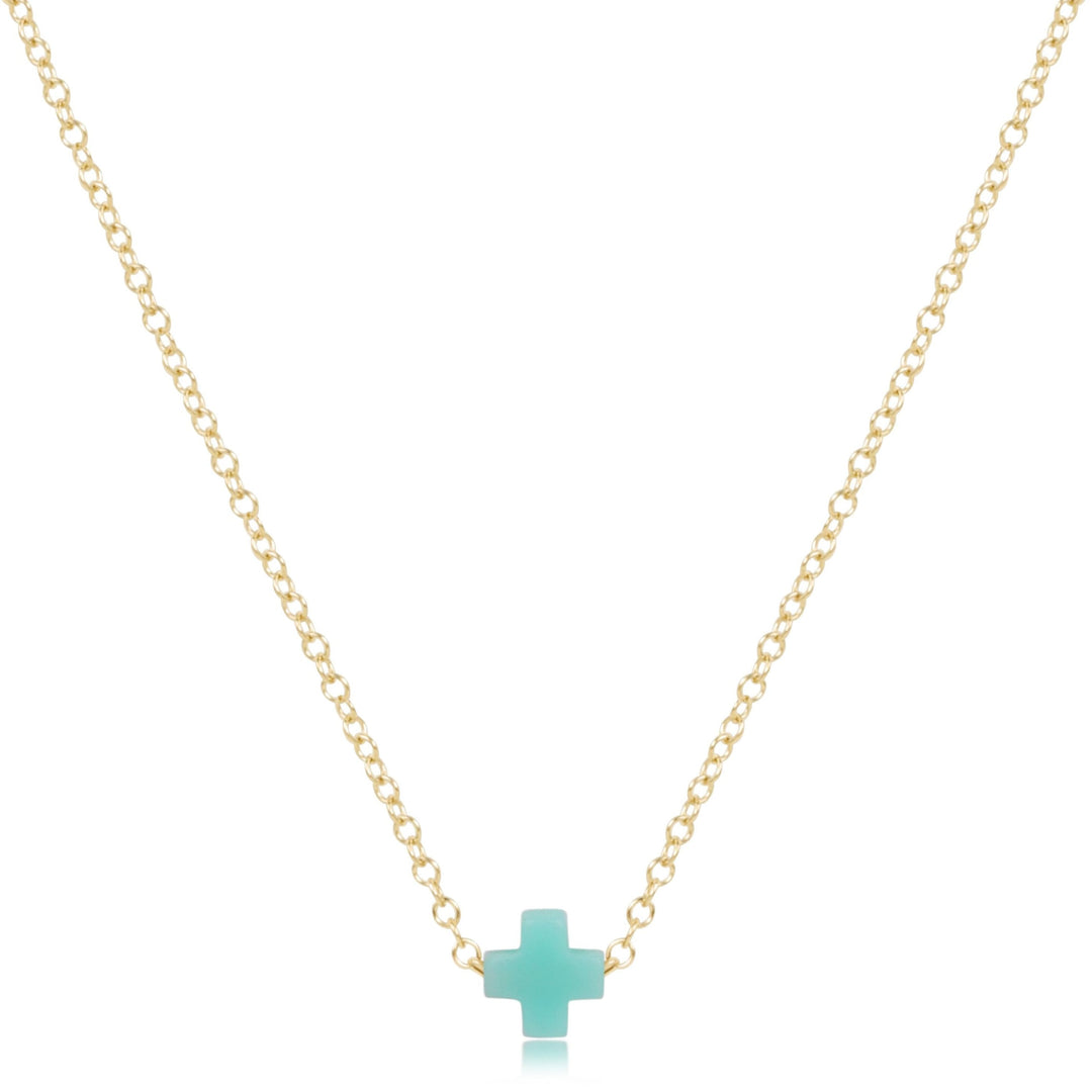 16-inch 14kt gold-filled chain necklace featuring a small turquoise-colored signature cross pendant.