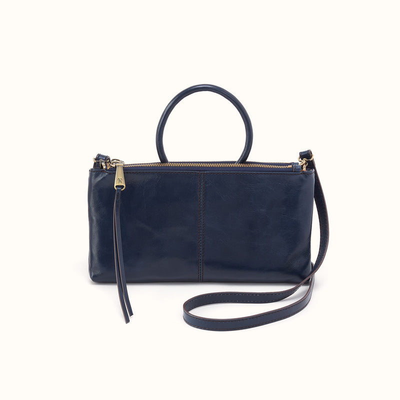 Ink navy leather Sable crossbody bag with a round top handle and removable shoulder strap.