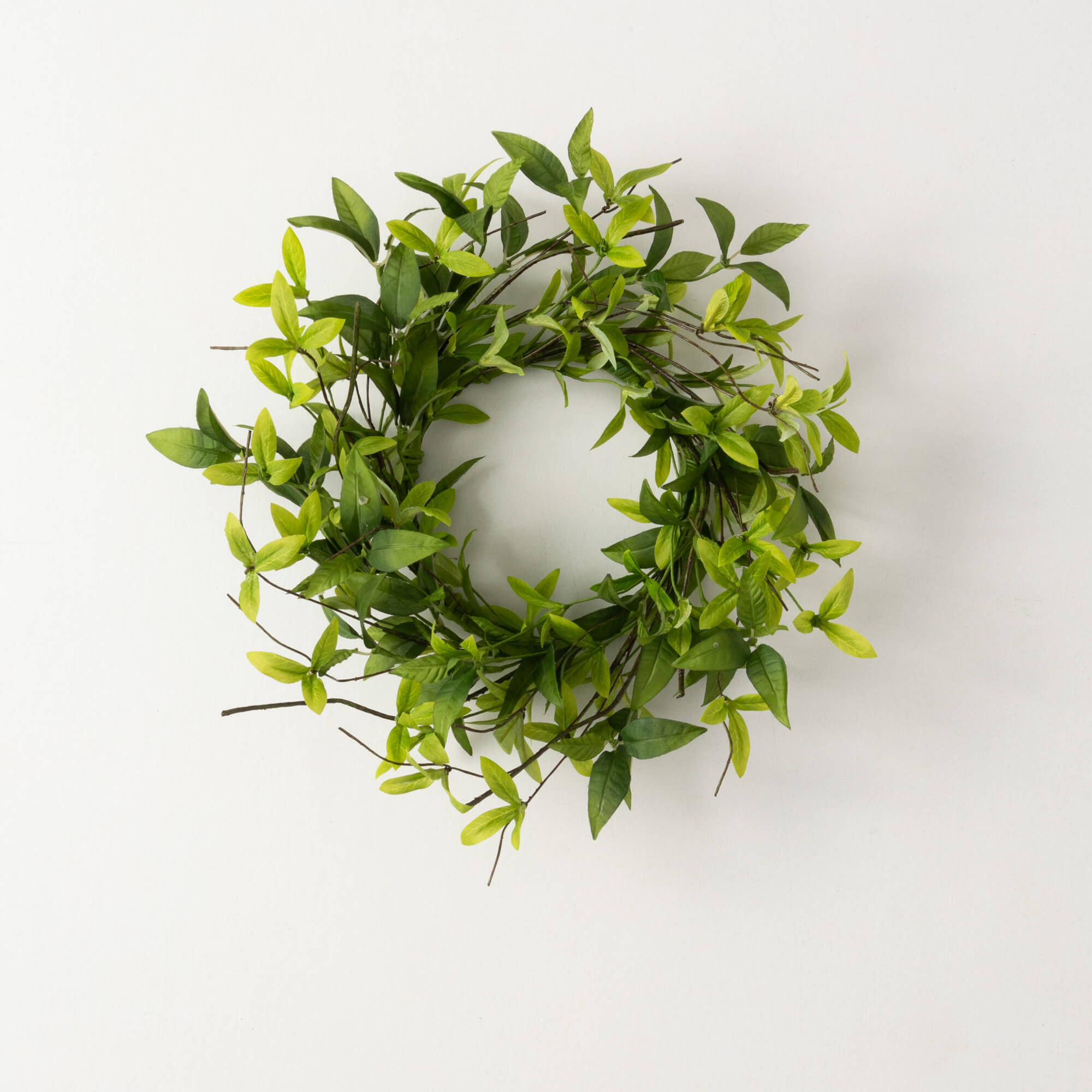 Green polyester ring wreath with ruscus leaves and twigs