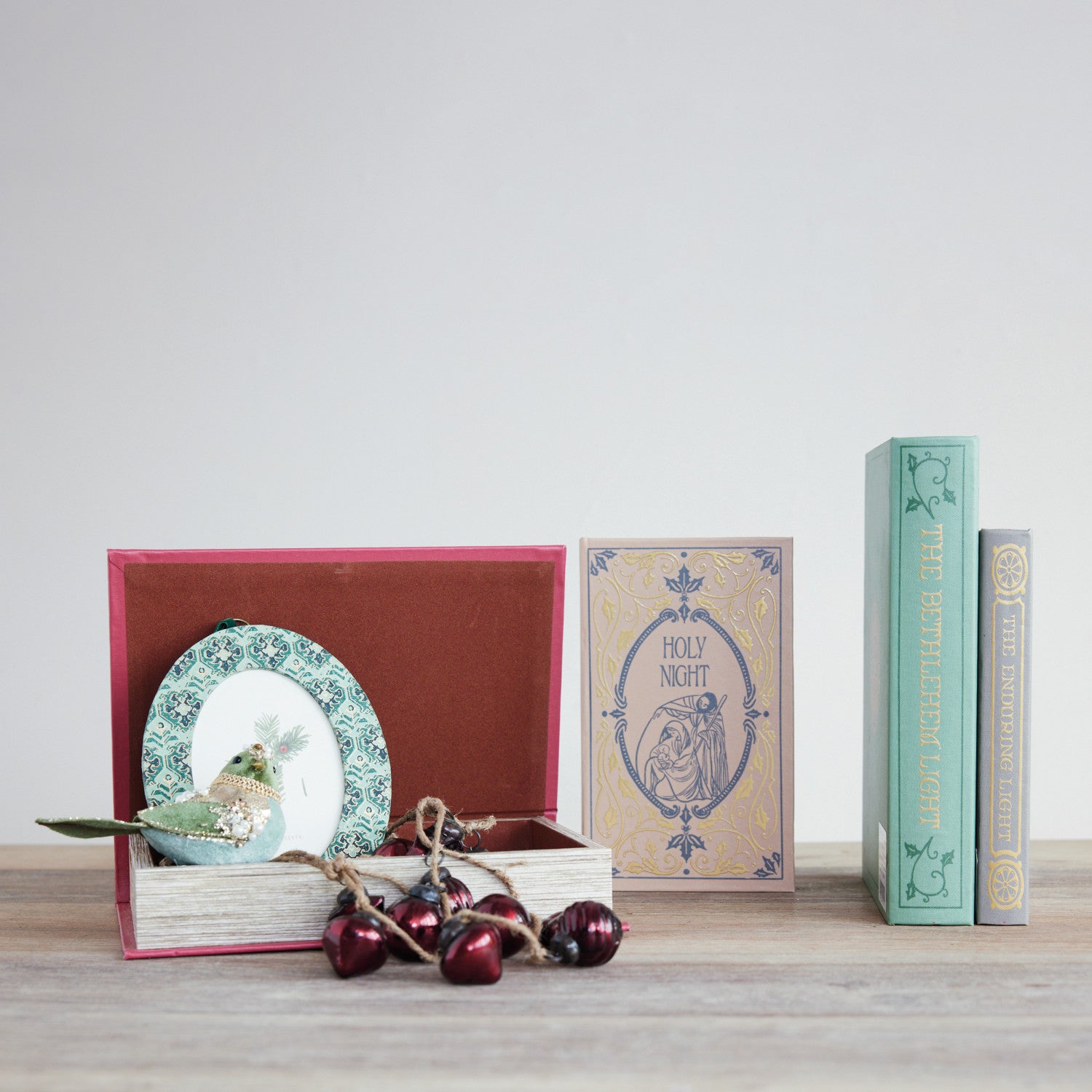 Set of 2 MDF and canvas book storage boxes with vintage Christmas prints on a wooden surface.