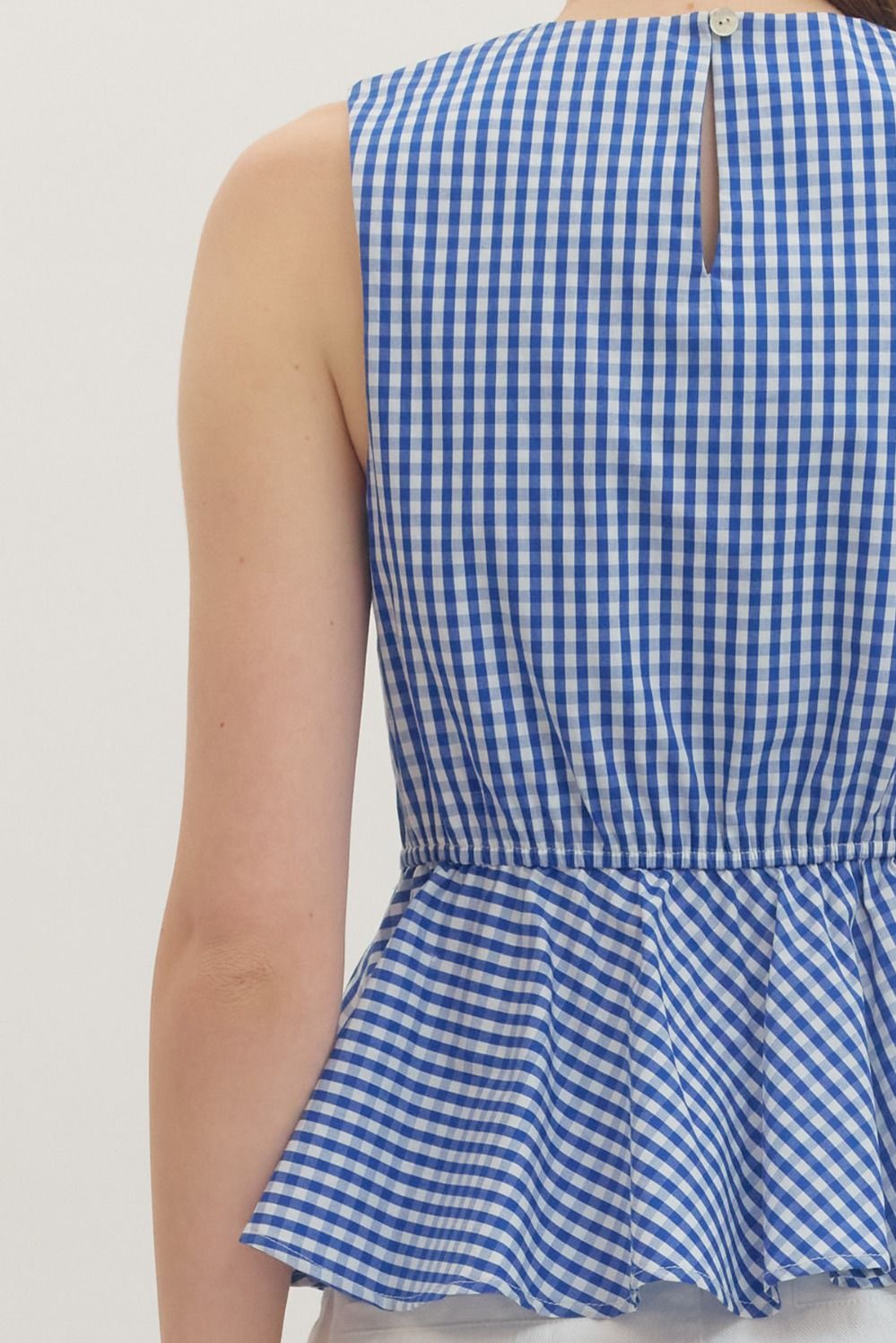 Jessica Gingham sleeveless peplum top in white cotton with asymmetric front ruffle and elasticated back waist.