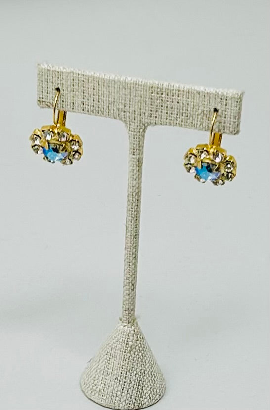 Gold round stud earrings featuring a central stone with pave setting.