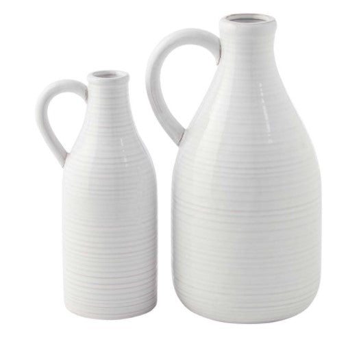 Clear glass milk jug vase with a narrow neck and wide cylindrical body.