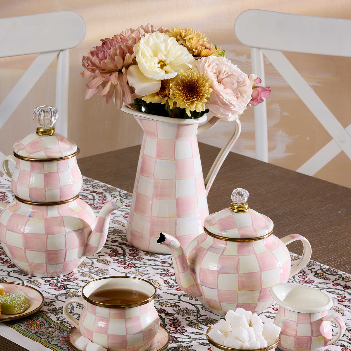 Rosy Check Medium Practical Pitcher filled with flowers on a table with matching tea set.
