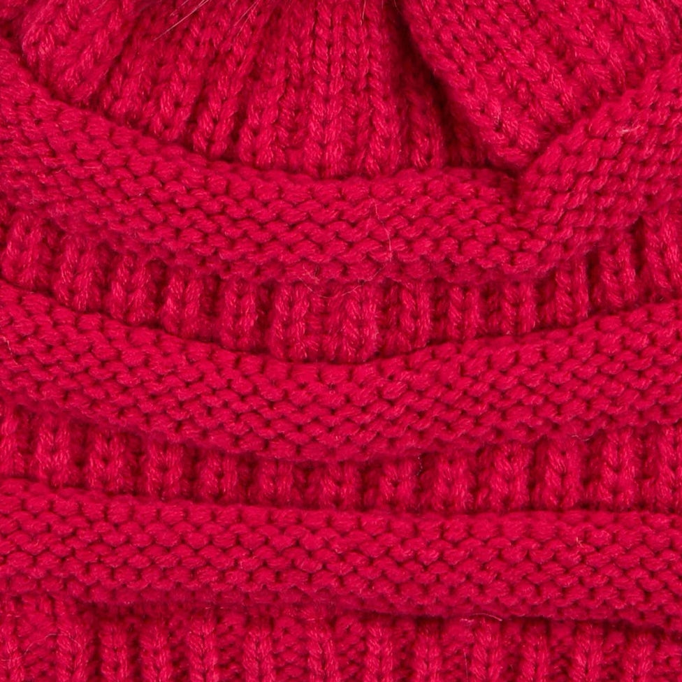 Hot pink cable knit beanie with faux fur pom on top