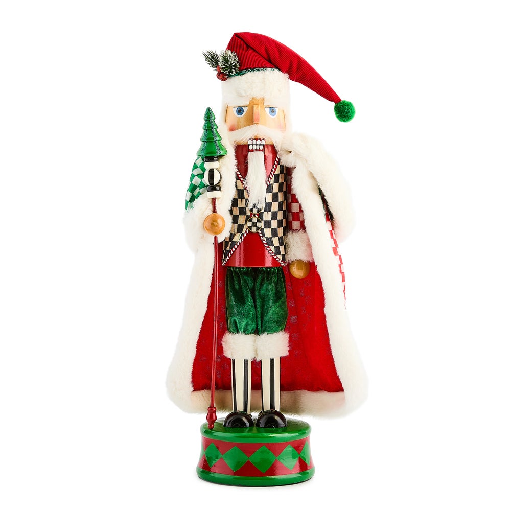 Check It Out Nutcracker in a red hat and fur-trimmed cloak holding a staff with a green tree top.