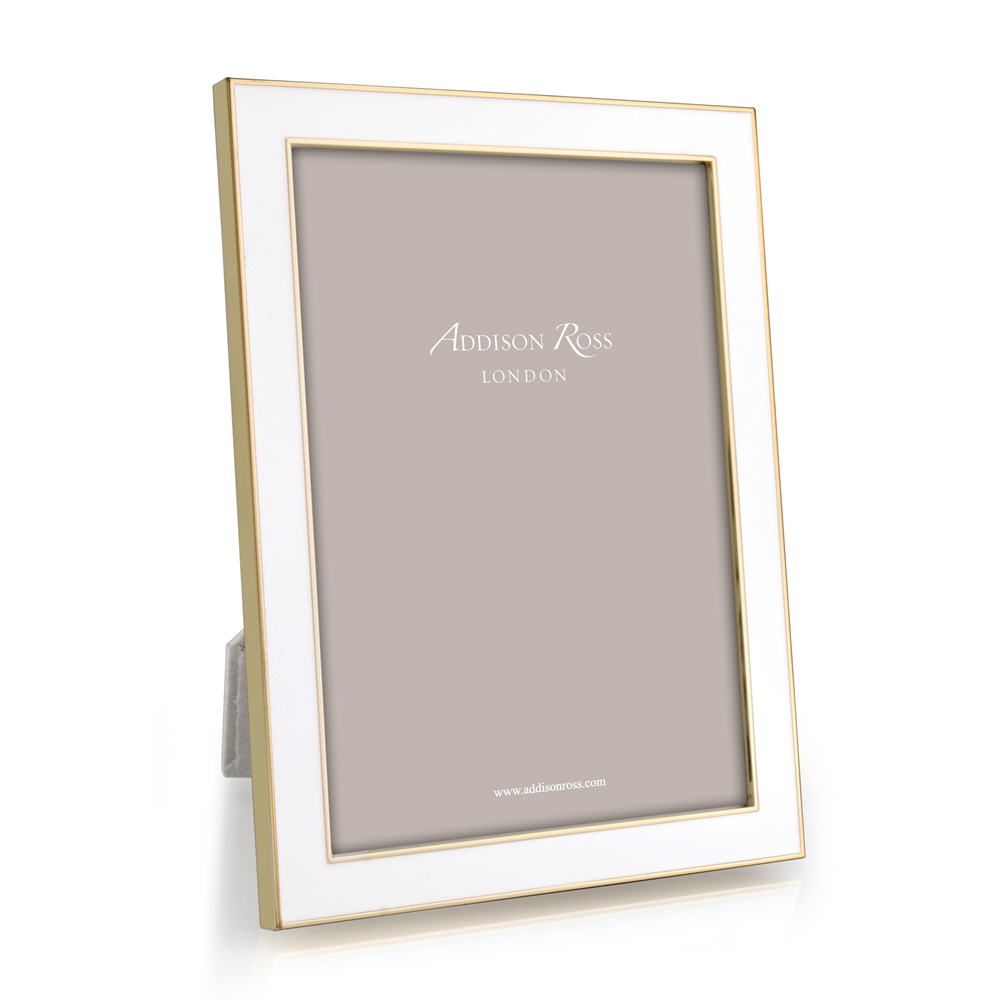 White enamel frame with gold trim holding a photo in gray velvet backing