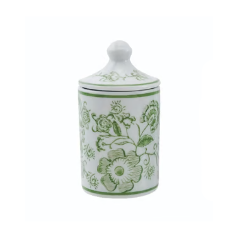 Hand-stamped white stoneware spice jar with green floral patterns and a matching lid.