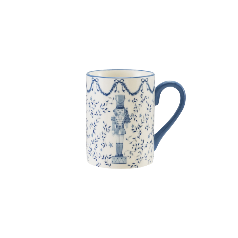 12 oz. white ceramic mug with blue nutcracker illustration, vine patterns, and a blue handle.