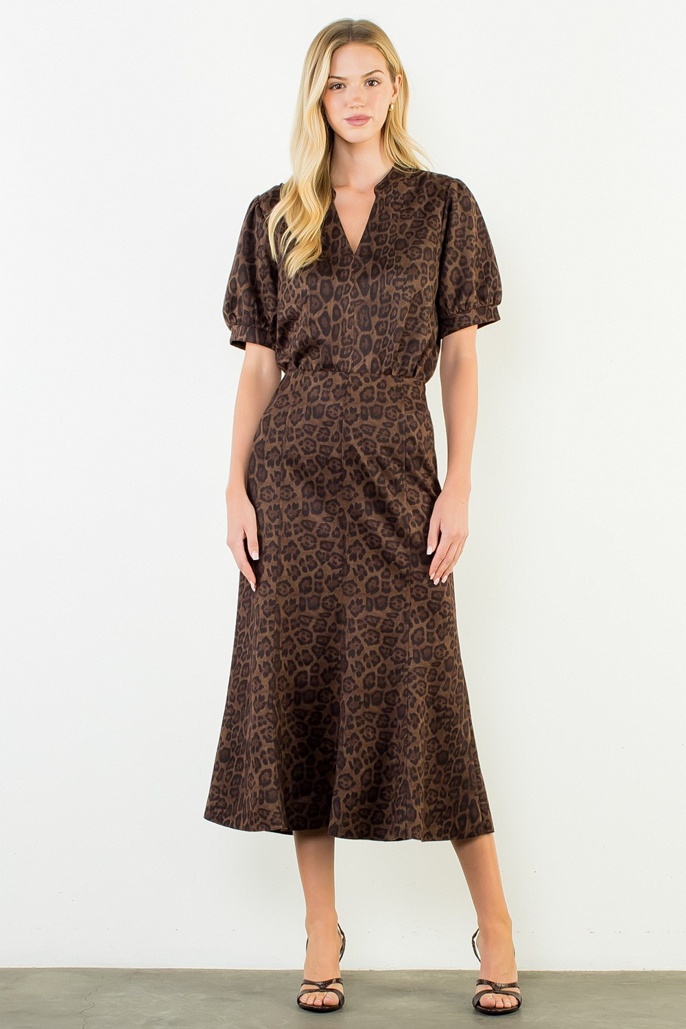 Woman wearing the Stella Suede Animal Print Top with a split neckline and short puff sleeves.