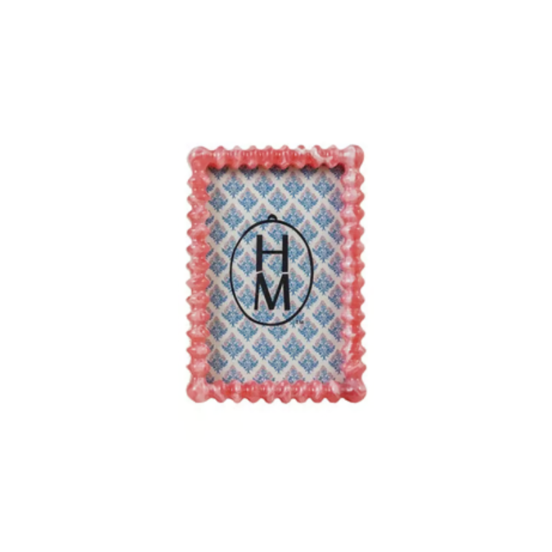 Pink marbled resin frame with scalloped edges and a blue floral pattern insert.
