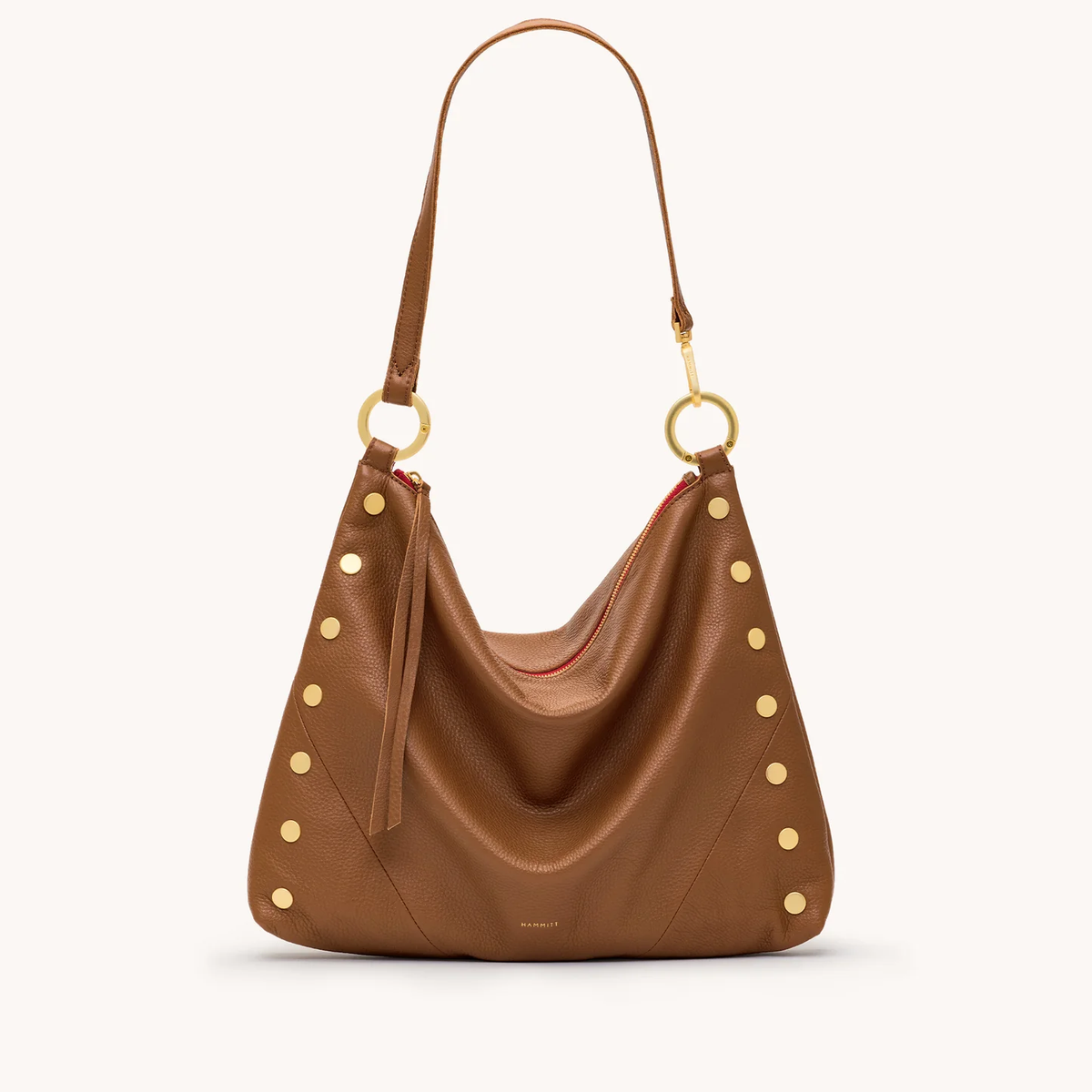 Mahogany pebble leather hobo bag with gold studs, red zipper, and a long shoulder strap.