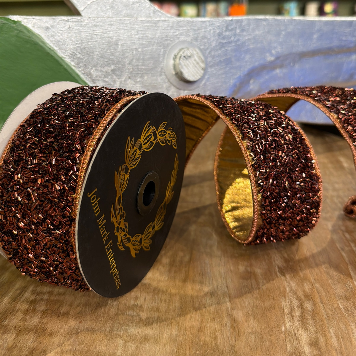 2.5 inch brown confetti sprinkle trim ribbon with gold metallic dupion backing on a spool.