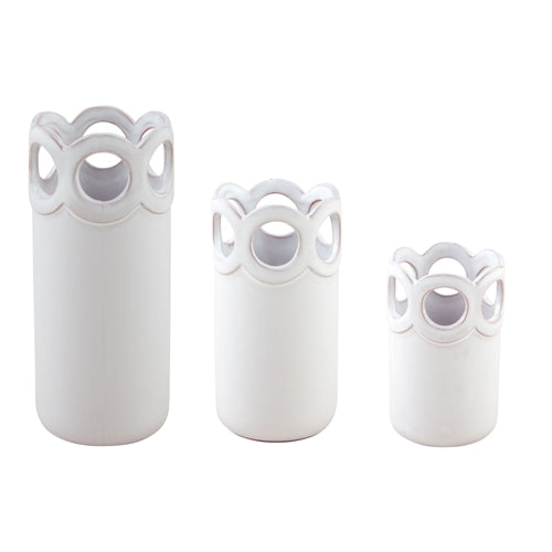 Set of three white terracotta scalloped bud vases in varying heights with circular cutouts.