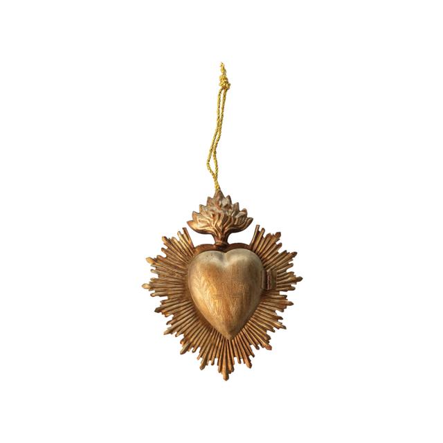 Embossed metal sacred heart locket ornament with a golden finish and hanging string.